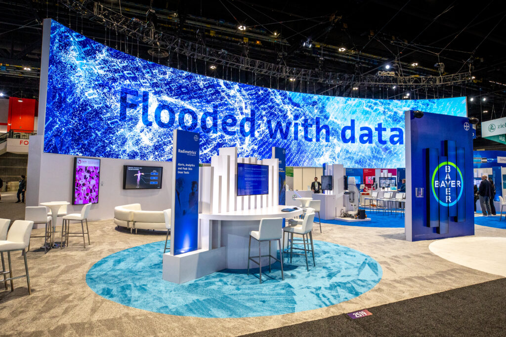 Part of the Bayer booth at a convention featuring a "water wall".