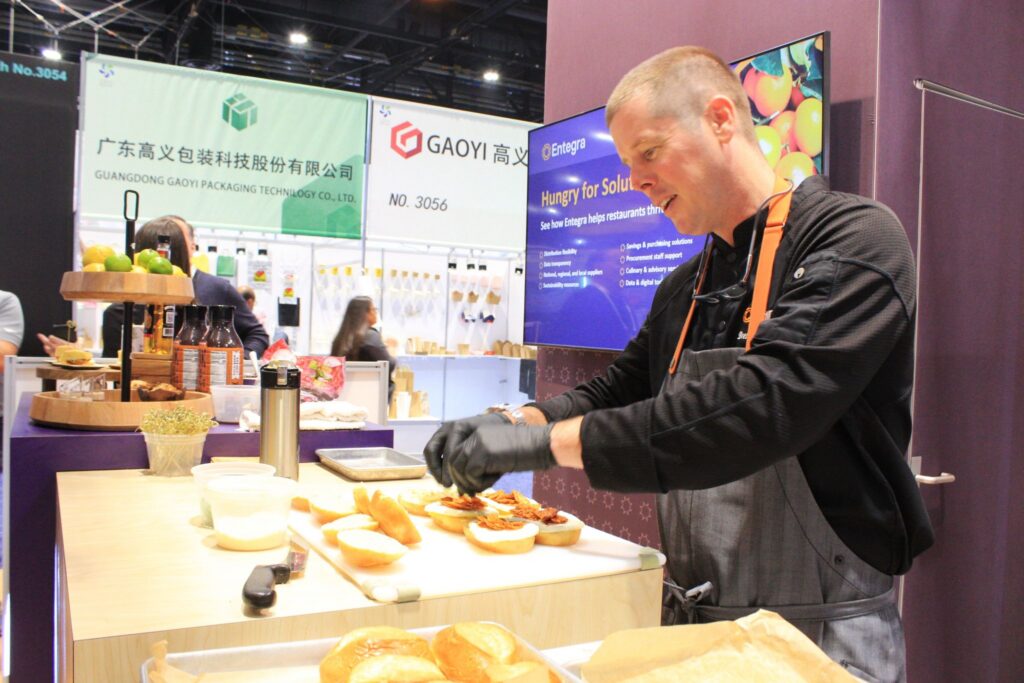 Chef preparing food samples in a trade show booth
